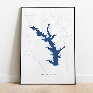 May include: A black framed print of a map of Lake Limestone in Texas. The lake is shown in blue, with surrounding roads and features in white.