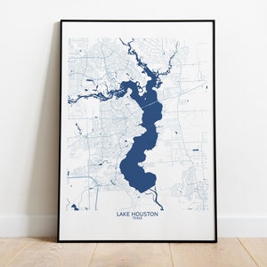 May include: A framed map of Lake Houston, Texas, with a blue outline of the lake and surrounding roads and waterways. The map is printed on white paper and has a black frame.