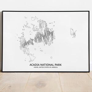 May include: A black and white line art print of Acadia National Park in Maine, United States of America. The print shows the outline of the park with detailed lines representing the terrain.