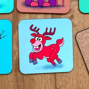 May include: A red reindeer with a pink nose and big white teeth runs across a light blue background. The reindeer has brown antlers and white spots.