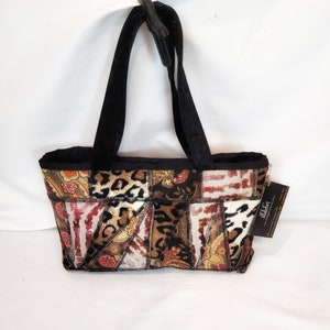 May include: A black and brown patchwork tote bag with black velvet straps. The bag features a variety of patterns including leopard print, paisley, and floral designs. The bag has a small tag attached to it that says "Made For You".