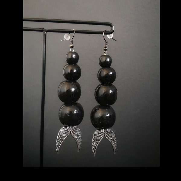 Boucles d'oreilles pendantes grosses perles en bois noires et ailes argentées