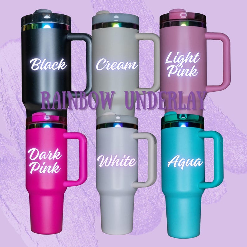 May include: Six stainless steel travel mugs with different colored bodies and rainbow underlays. The colors are black, cream, light pink, dark pink, white, and aqua. The mugs have a handle and a lid.