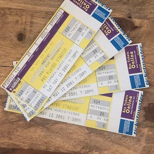 May include: Five yellow concert tickets for *NSYNC's 2001 Pop Odyssey tour at Pro Player Stadium in Miami, Florida. The tickets are dated 12 May 2001, and the show starts at 7:30 PM. The tickets are for section 28, row 5, seat 5. The tickets are printed on yellow paper with black text and a blue and white Ticketmaster logo.