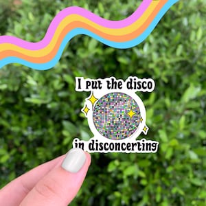 May include: A sticker with a disco ball and the text "I put the disco in disconcerting".