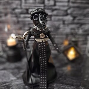 Handmade gothic plague doctor art doll viewed from a slightly right-tilted upper diagonal angle, showing intricate handcrafted details and dark vintage gothic design for collectible display.
