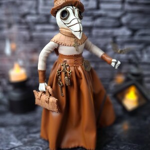 Handmade gothic plague doctor art doll viewed from lower right wide angle, displaying full figure with detailed handcrafted features and dark vintage gothic design.