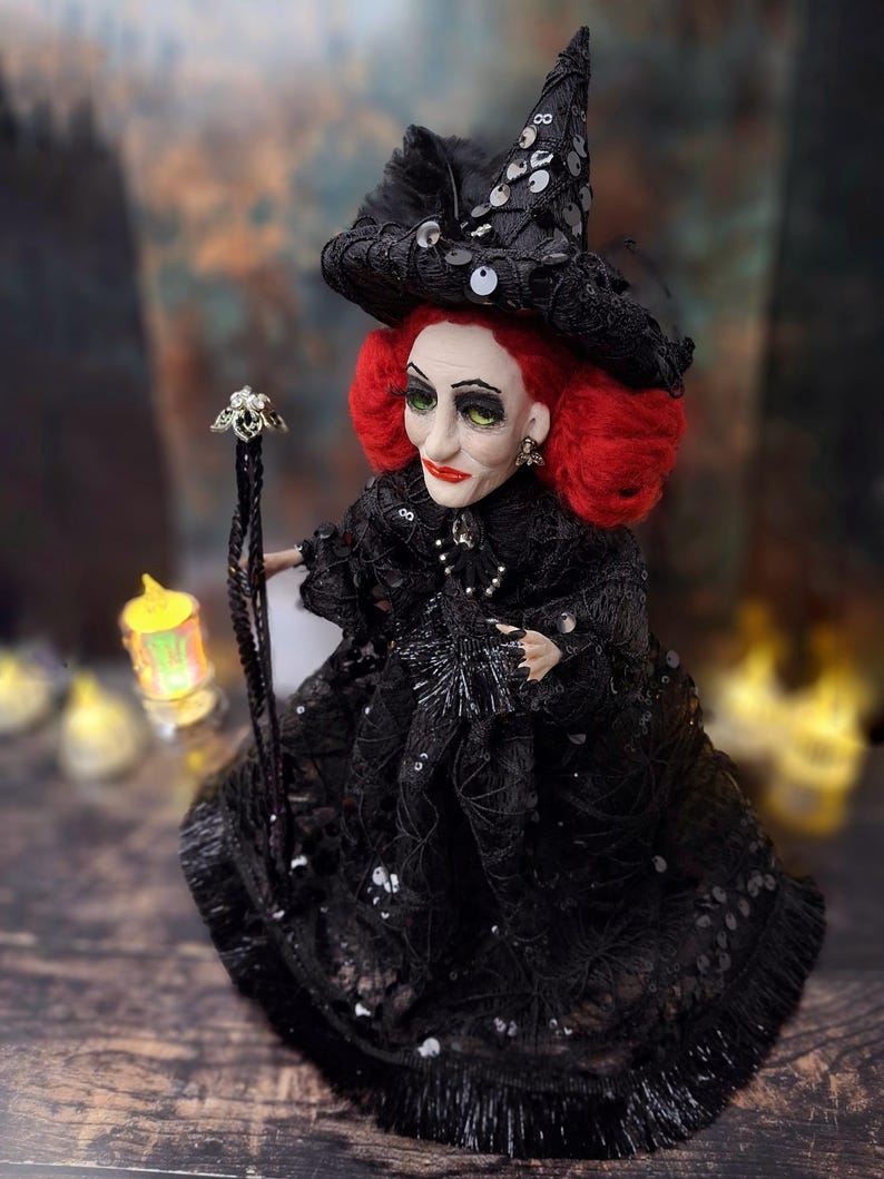 Top-down left side view of the handmade fancy witch art doll, showcasing her hand-painted face, whimsical witch outfit, and enchanting accessories.
