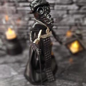 Handmade gothic plague doctor art doll viewed from upper right angle, detailed dark collectible with handcrafted textures and vintage gothic style for home display.