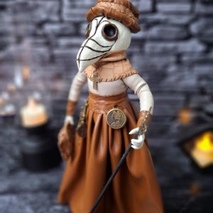 Handmade gothic plague doctor art doll in close-up left view, showcasing detailed handcrafted features and dark vintage gothic design.