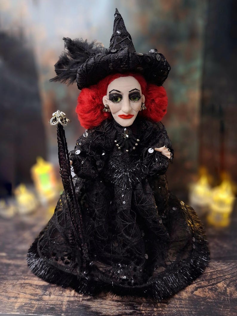 Front view of the handmade fancy witch art doll at medium distance, showing her hand-painted face, whimsical witch outfit, and enchanting accessories.