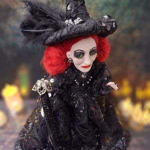 Close-up top-right side view of the handmade fancy witch art doll, showcasing her detailed hand-painted face, whimsical witch outfit, and enchanting accessories.
