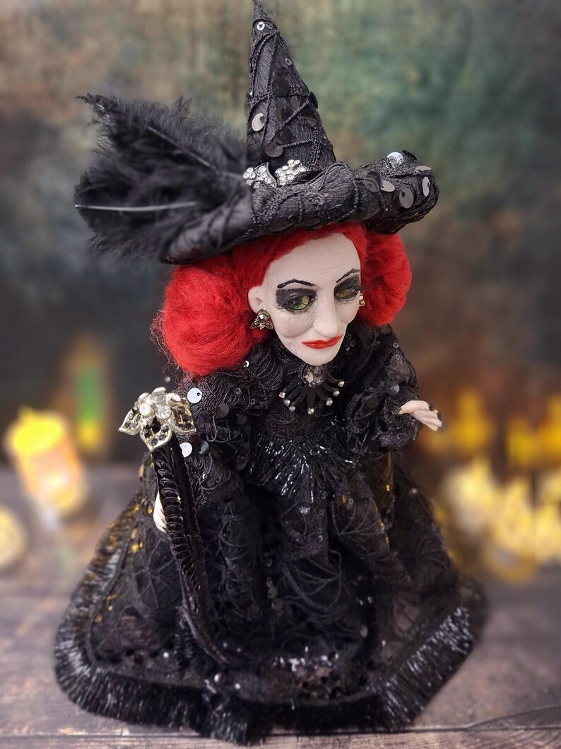 Close-up top-right side view of the handmade fancy witch art doll, showcasing her detailed hand-painted face, whimsical witch outfit, and enchanting accessories.