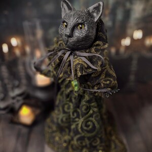 Front-left wide view of a handmade black cat doll standing and facing left, showcasing detailed sculpting, hand-painted features, and whimsical gothic design, a unique collectible perfect for black cat lovers, spooky home décor, Halloween displays, and gothic cat art collections.