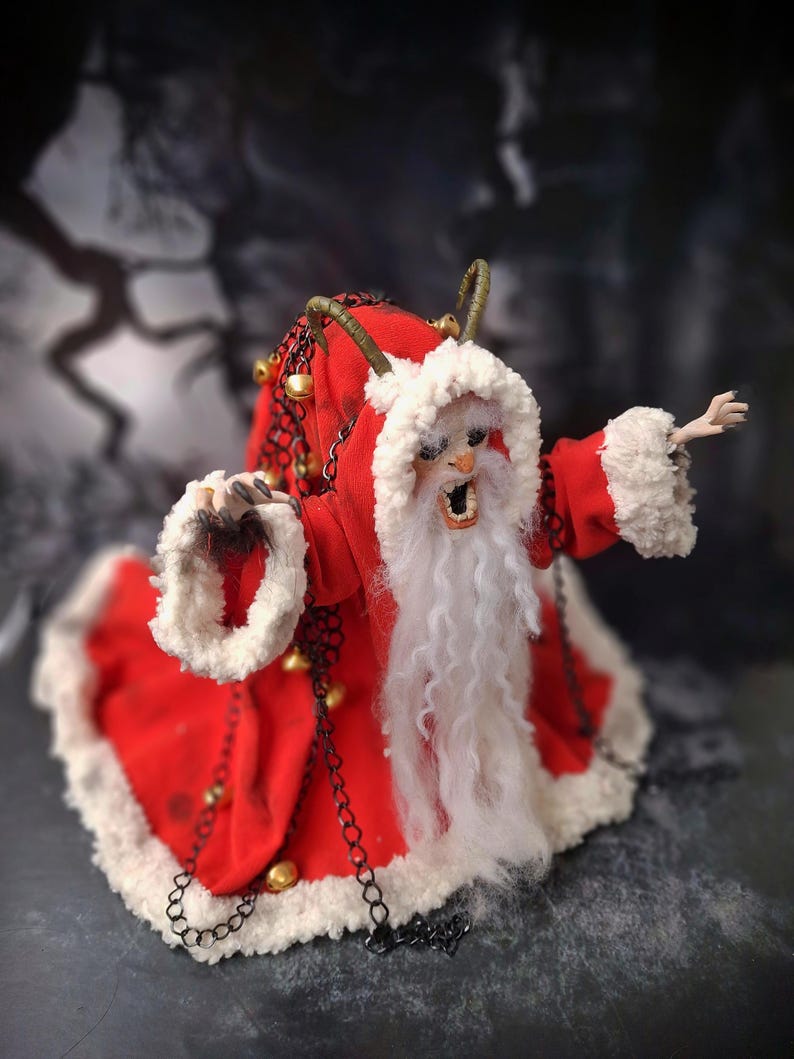 Top-down view of handmade Krampus art doll from right diagonal angle – spooky gothic Christmas collectible showing detailed sculpting, textures, and dark holiday decor.
