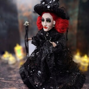 Left side view of the handmade fancy witch art doll, highlighting her hand-painted face, whimsical witch outfit, and enchanting accessories.