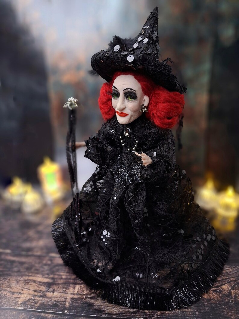 Left side view of the handmade fancy witch art doll, highlighting her hand-painted face, whimsical witch outfit, and enchanting accessories.