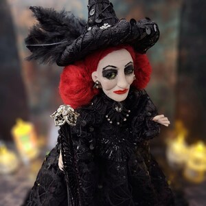 Close-up top-right side view of the handmade fancy witch art doll, highlighting her detailed hand-painted face, whimsical witch outfit, and enchanting accessories.