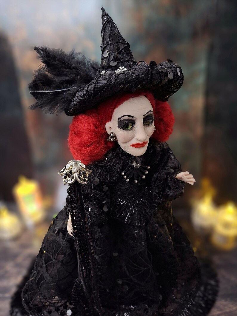 Close-up top-right side view of the handmade fancy witch art doll, highlighting her detailed hand-painted face, whimsical witch outfit, and enchanting accessories.