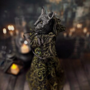 Left profile view of a handmade black cat doll standing, showing detailed sculpting, hand-painted features, and whimsical gothic design, a unique collectible perfect for black cat lovers, spooky home décor, Halloween displays, and gothic cat art collections.