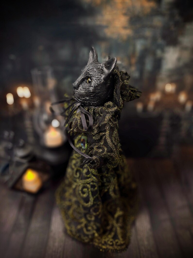 Left profile view of a handmade black cat doll standing, showing detailed sculpting, hand-painted features, and whimsical gothic design, a unique collectible perfect for black cat lovers, spooky home décor, Halloween displays, and gothic cat art collections.