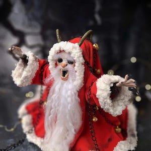 Close-up of handmade Krampus art doll tilted slightly to the left – spooky gothic Christmas collectible showing detailed sculpting, textures, and dark holiday decor.