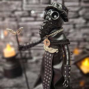 Handmade gothic plague doctor art doll in close-up left view, highlighting handcrafted details and dark vintage design for gothic collectible display.