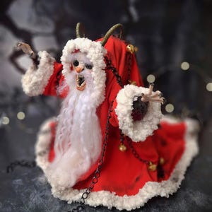 Handmade Krampus art doll from left diagonal angle – spooky gothic Christmas collectible showing detailed sculpting, textures, and dark holiday decor.