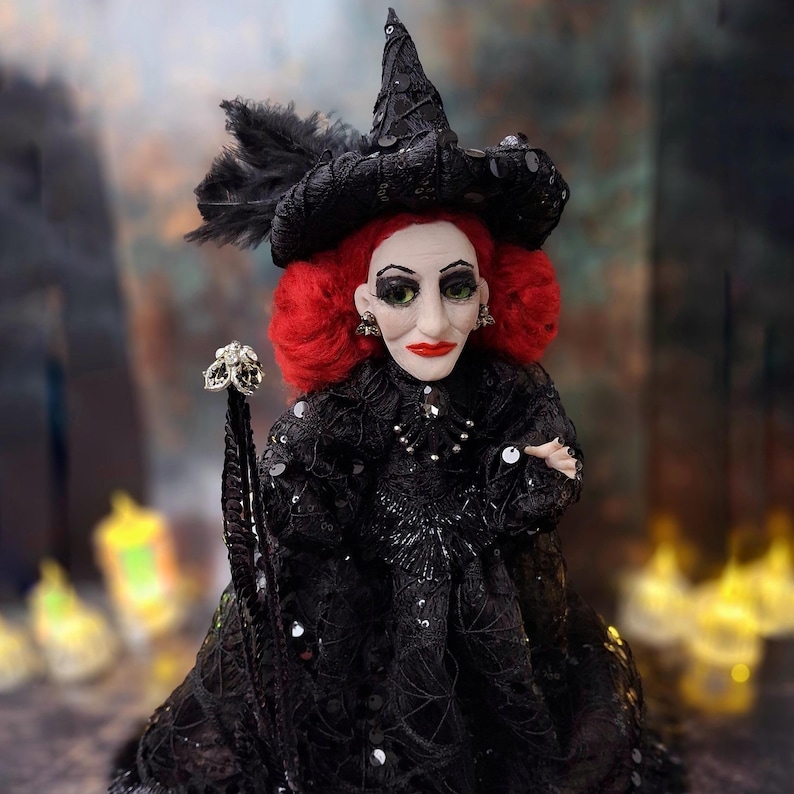 Close-up front view of the handmade fancy witch art doll, showing her detailed hand-painted face, whimsical witch outfit, and enchanting accessories.