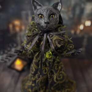 Slightly front-left angled view of a handmade black cat doll standing, featuring whimsical gothic design, hand-painted details, and sculpted features, a unique collectible perfect for black cat lovers, spooky home décor, Halloween displays, and gothic cat art collections.