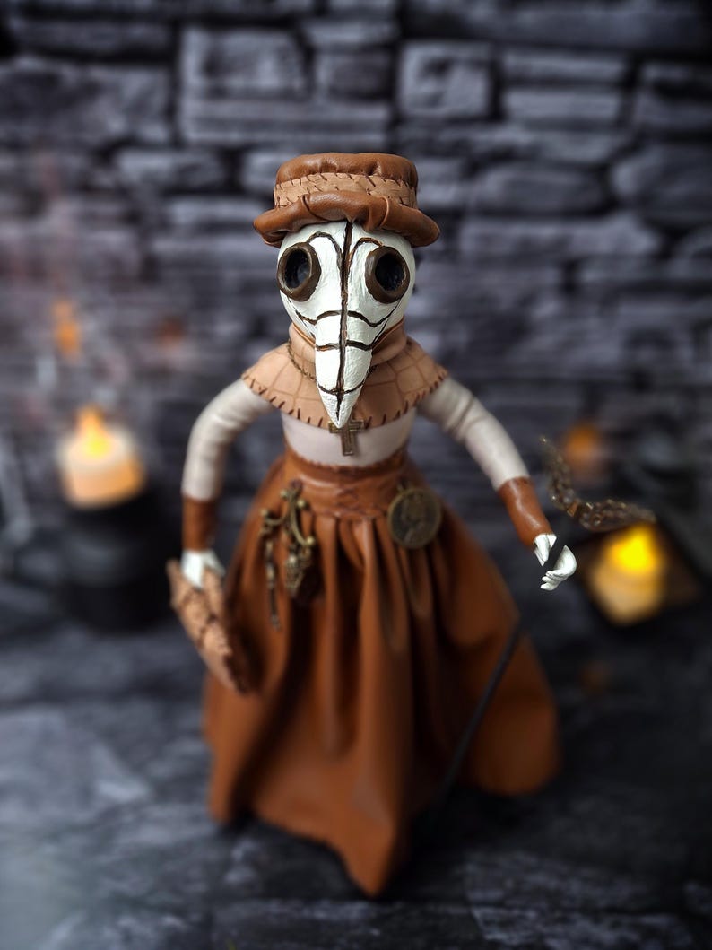 Handmade gothic plague doctor art doll viewed from straight top angle, showing detailed handcrafted features and dark vintage gothic design.