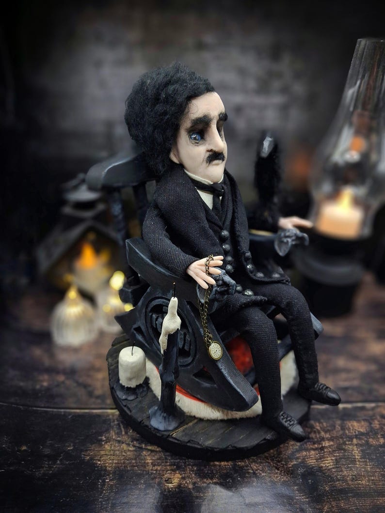 Mid-angle view from the right of a handmade Edgar Allan Poe art doll sitting on a rocking chair on a small carpeted stand, with a raven perched nearby, a poseable art doll and unique Poe collectible perfect for literary decor, gothic home accent, and dark fantasy displays, highlighting detailed sculpting and painted features.