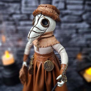 Handmade gothic plague doctor art doll shown from left side profile, highlighting handcrafted details and dark vintage gothic design.