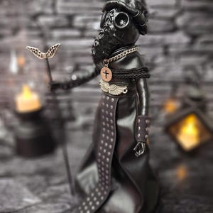 Handmade gothic plague doctor art doll in close-up left view, displaying detailed handcrafted features and dark vintage design for gothic collectible display.