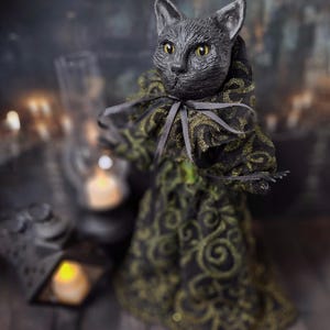 Front-left diagonal wide view of a handmade black cat doll standing, featuring whimsical gothic design, detailed sculpting, and hand-painted details, perfect for spooky home décor, Halloween displays, gothic black cat collections, and as a unique cat collectible or gift.