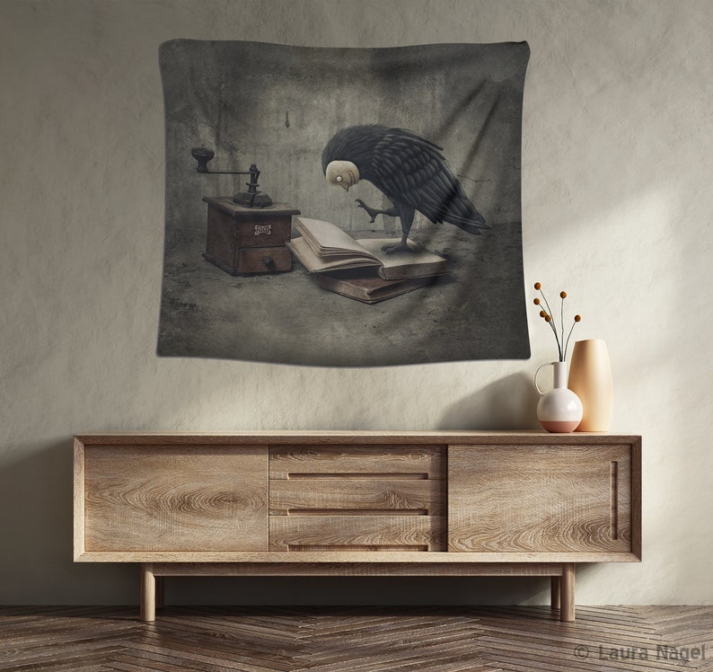 May include: A black and white tapestry featuring a bird with a human-like face looking at an open book and a vintage coffee grinder. The background is a textured gray wall.