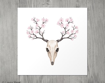 May include: Watercolor illustration of a deer skull with dark antlers and branches adorned with pink cherry blossoms. The artwork is set against a white background, creating a striking contrast. The image has a natural, botanical theme.