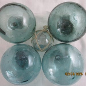 Set of Four, 4" inch hand blown Antique Japanese glass floats plus a tiny float