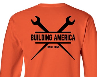 May include: Orange long-sleeve t-shirt with a black logo on the back. The logo features two crossed wrenches with the text "BUILDING AMERICA SINCE 1996".