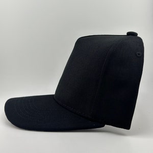 May include: A black baseball cap with a flat brim and a mesh back.