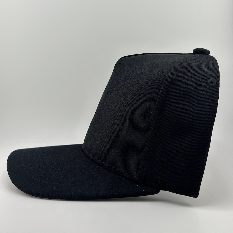 May include: A black baseball cap with a flat brim and a mesh back.