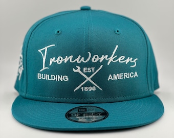 May include: Teal blue baseball cap with a white embroidered logo that says "Ironworkers Building America Est. 1896" with a wrench and hammer crossed underneath the text.
