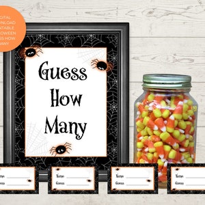 May include: Printable Halloween game with a black and white spiderweb background. The game is called "Guess How Many" and has a space for names and guesses. There is a jar of candy corn in the background.