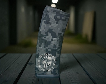 May include: A digital camouflage magazine with a skull graphic and the text "2ND AMENDMENT, COME AND TAKE IT". The magazine is primarily gray and black, with a rectangular shape and a curved design.