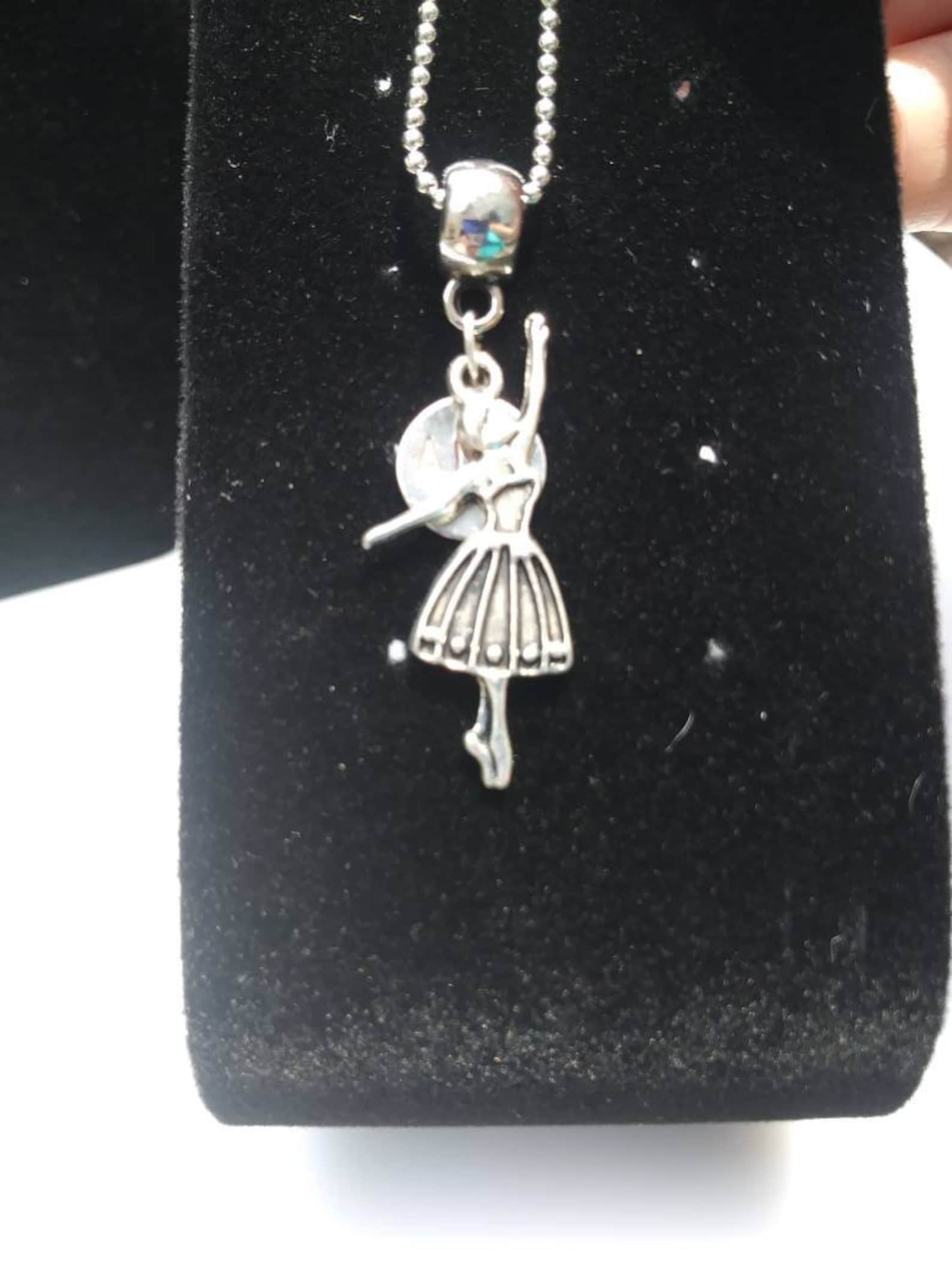 ballet shoes or ballet dancer hung on barrel bead charm holder and hung from silver plated/nickel free ballchain or black cordag