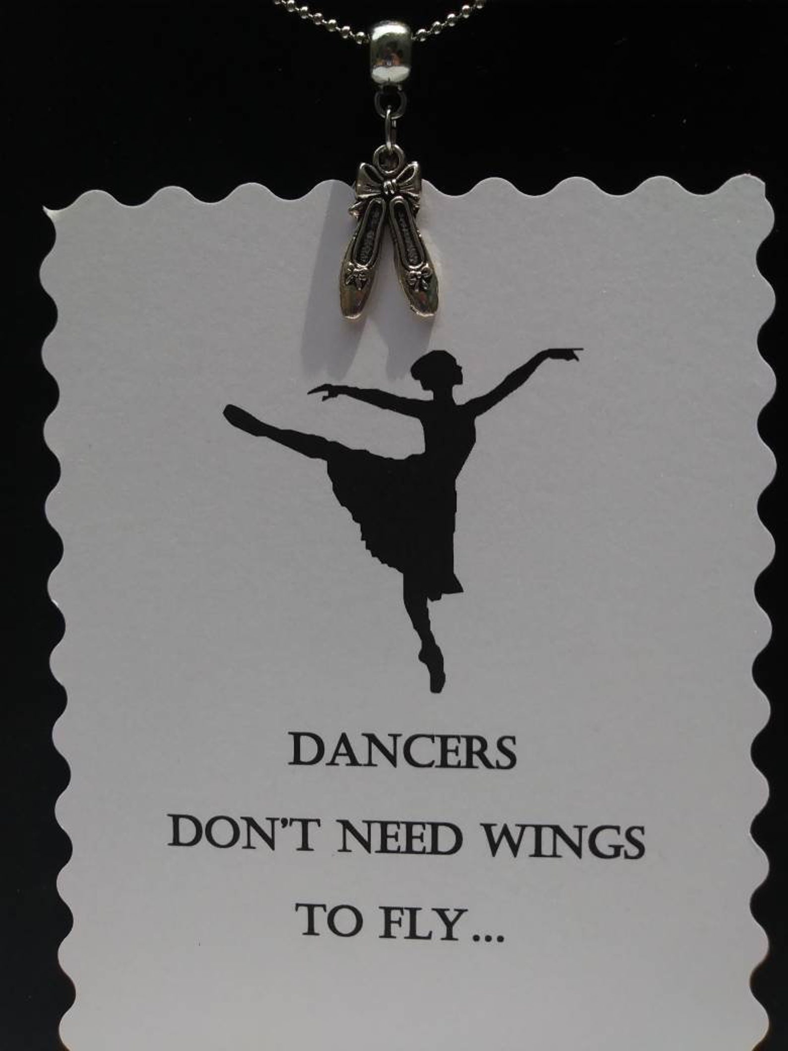 ballet shoes or ballet dancer hung on barrel bead charm holder and hung from silver plated/nickel free ballchain or black cordag