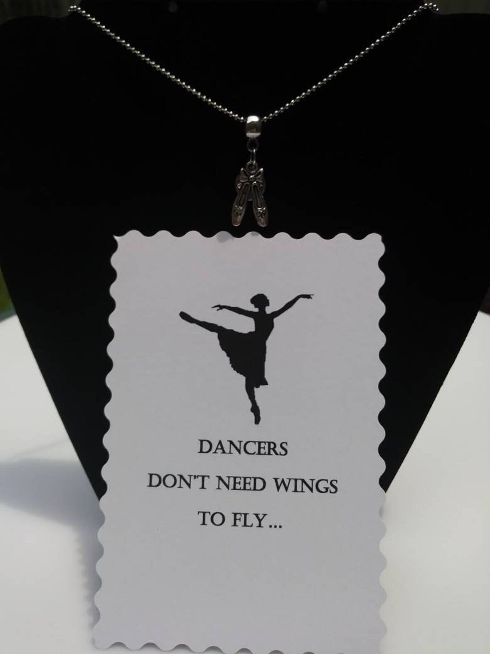 ballet shoes or ballet dancer hung on barrel bead charm holder and hung from silver plated/nickel free ballchain or black cordag