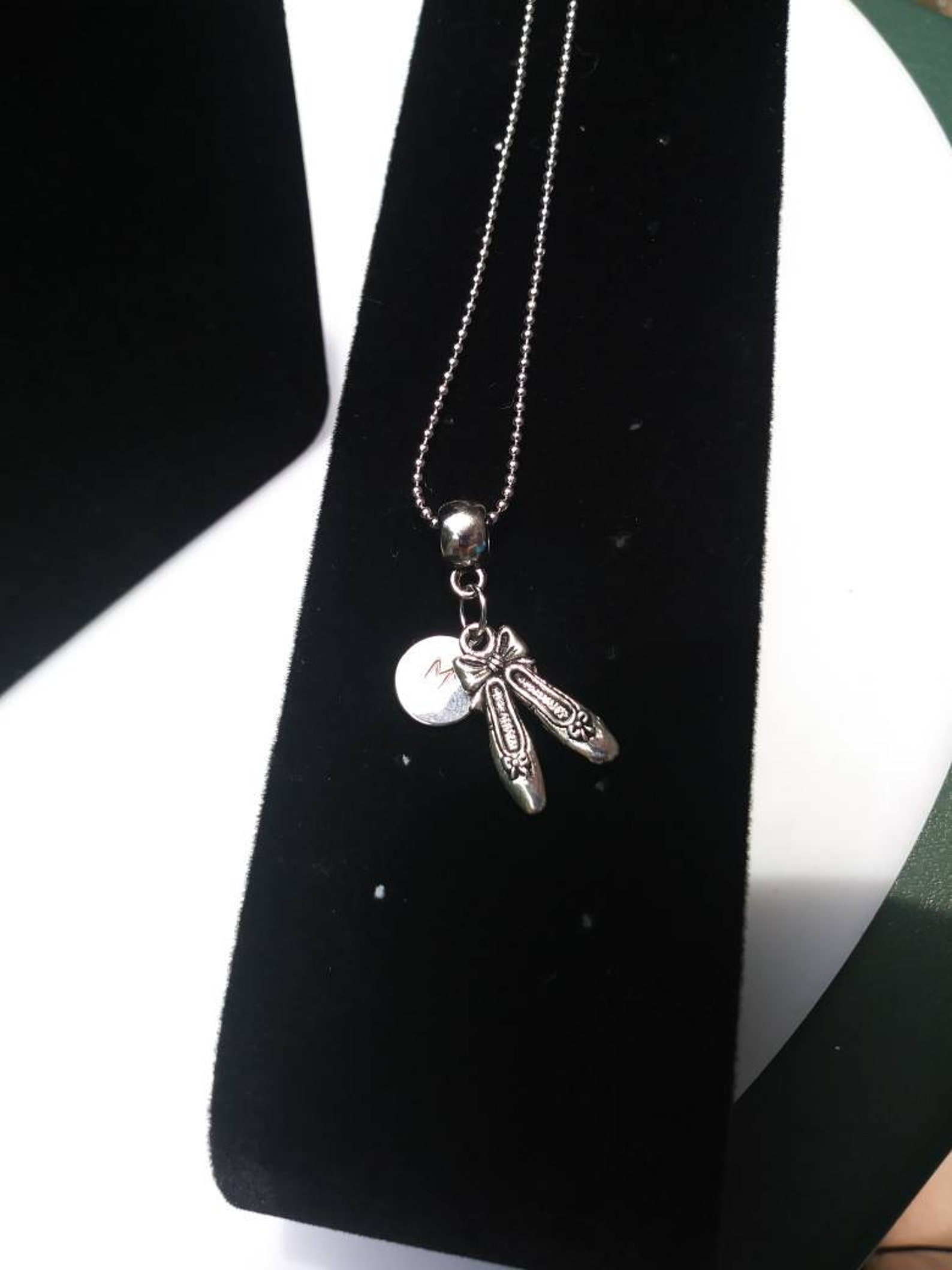 ballet shoes or ballet dancer hung on barrel bead charm holder and hung from silver plated/nickel free ballchain or black cordag