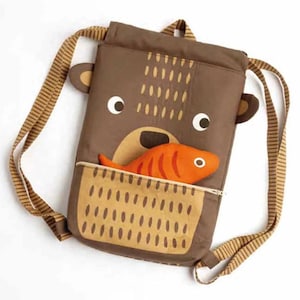 May include: A brown drawstring backpack with a bear face and a fish in its mouth. The backpack has a brown and white striped strap.