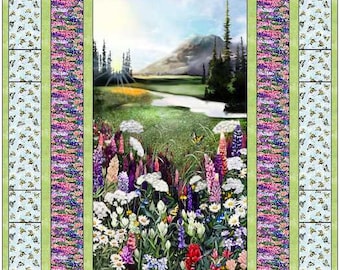 May include: A quilt block featuring a nature scene with a mountain range, a stream, and a field of wildflowers. The block is surrounded by a border of green and purple lupine flowers.